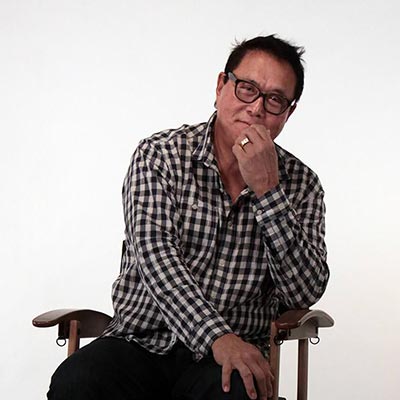 Robert Kiyosaki sitting in the directors chair