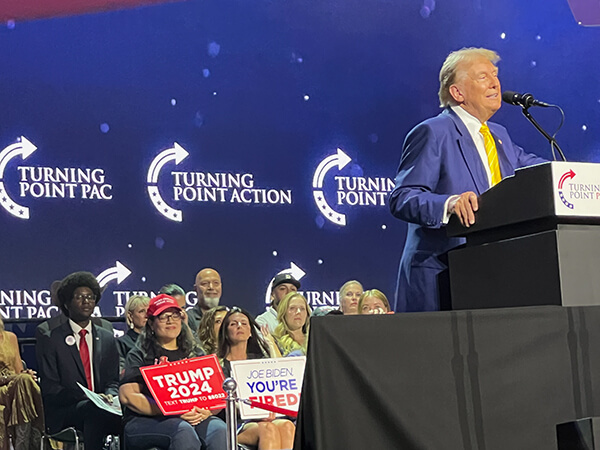 donald trump on stage at turning point action event