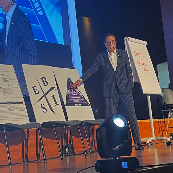 photo of robert on stage discussing business